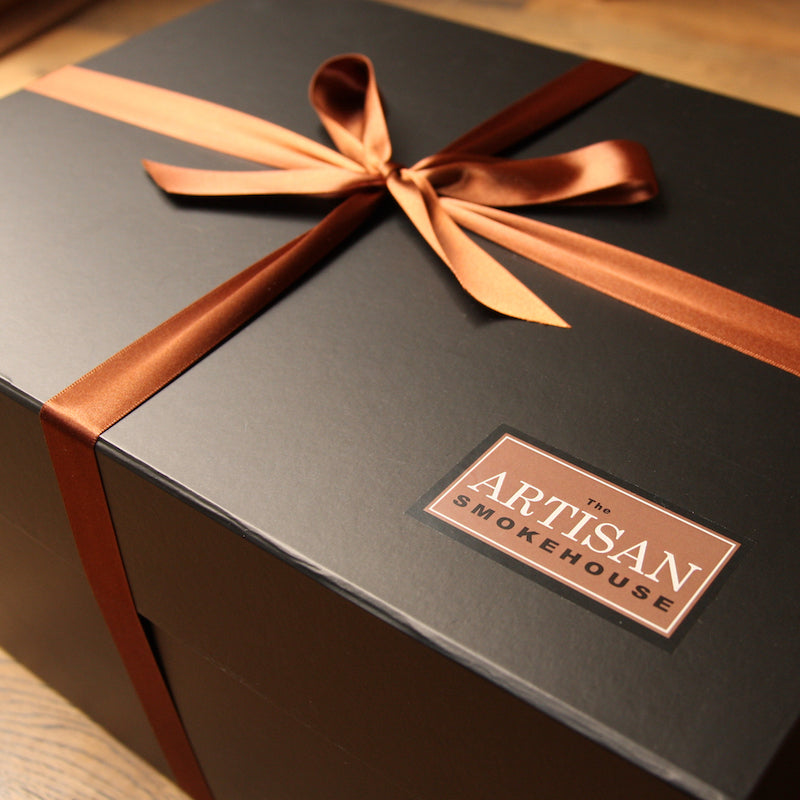 An Artisan Smokehouse luxury bespoke hamper tied with ribbon