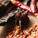 A selection of smoked chillies on chopping board