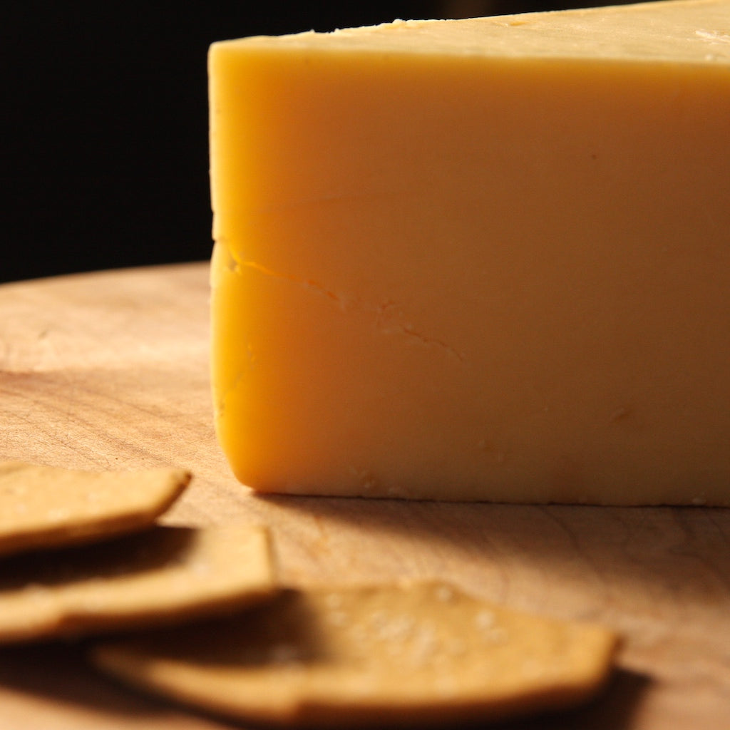 A piece of The Artisan Smokehouse's smoked mature Cheddar with crackers