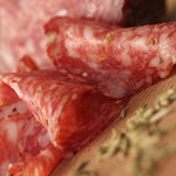 Slices of smoked Finochionna salami on board