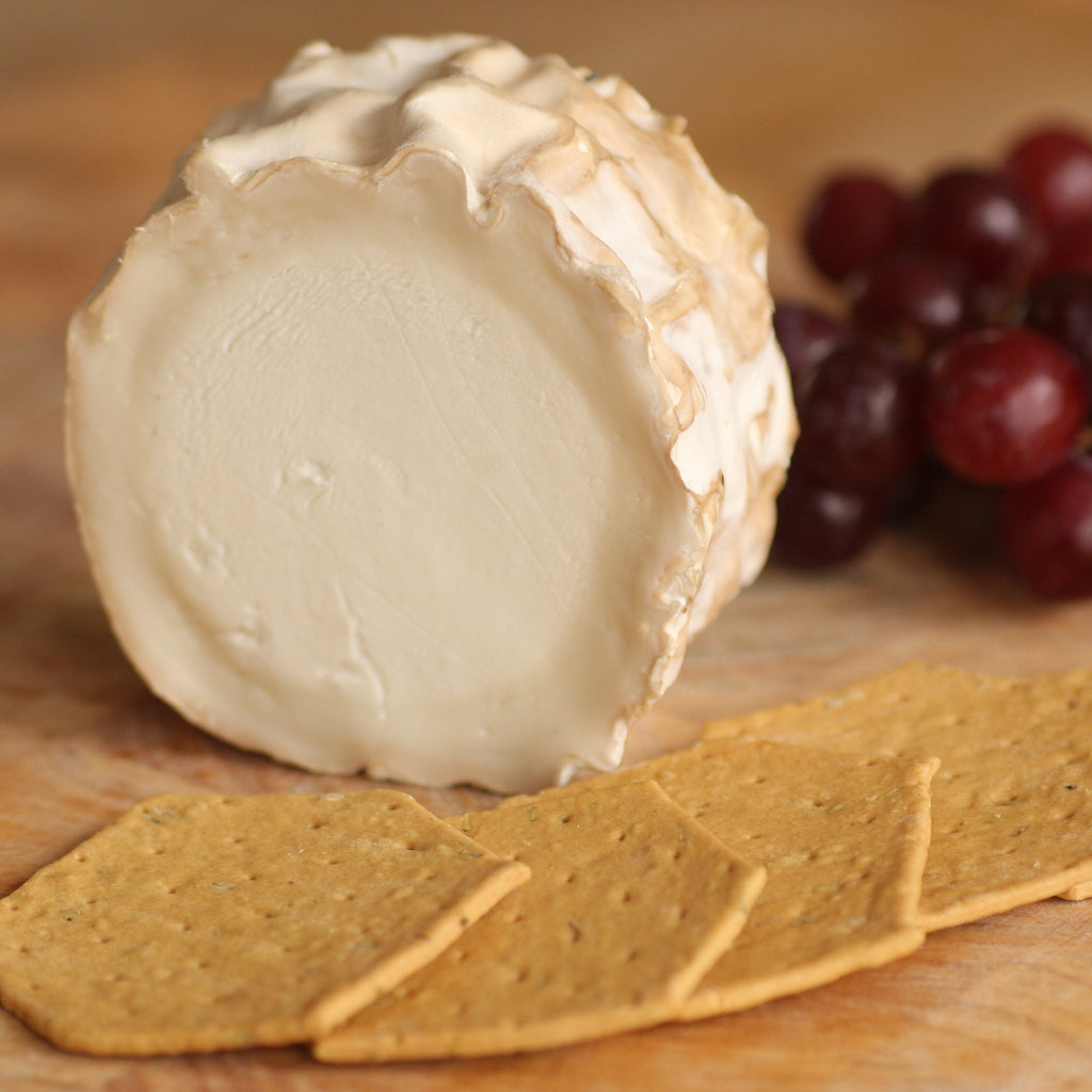 A piece of The Artisan Smokehouse's smoked goats cheese on cheese board