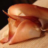 Sliced smoked Prosciutto on board