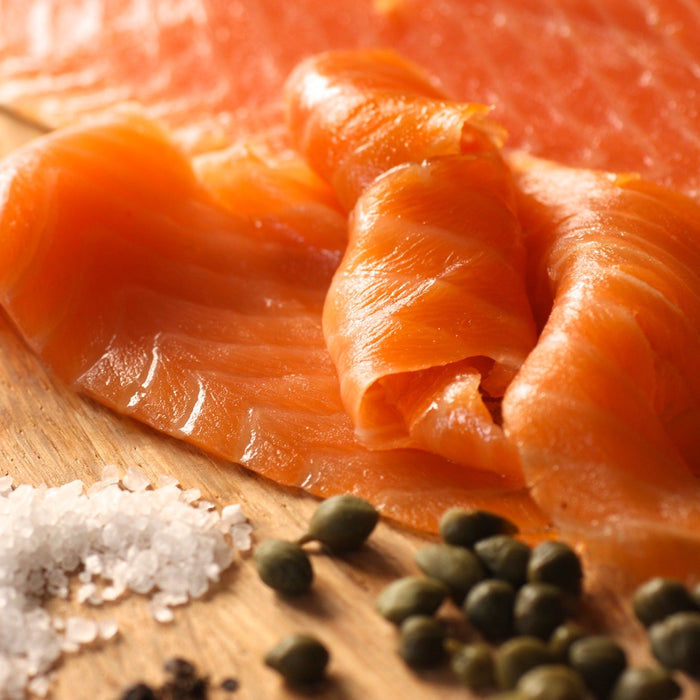 Slices of smoked salmon on wooden board