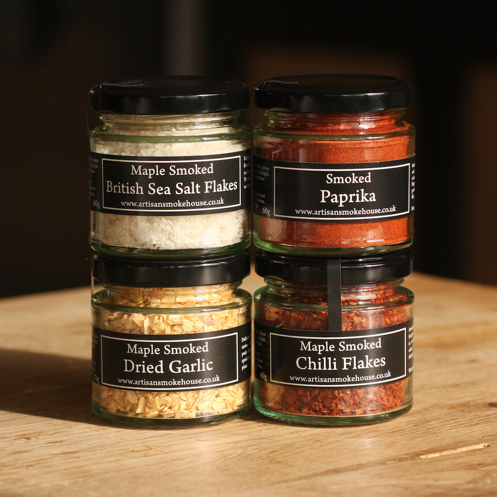 A jar of Artisan Smokehouse's smoked British sea salt with other jars of smoked spices